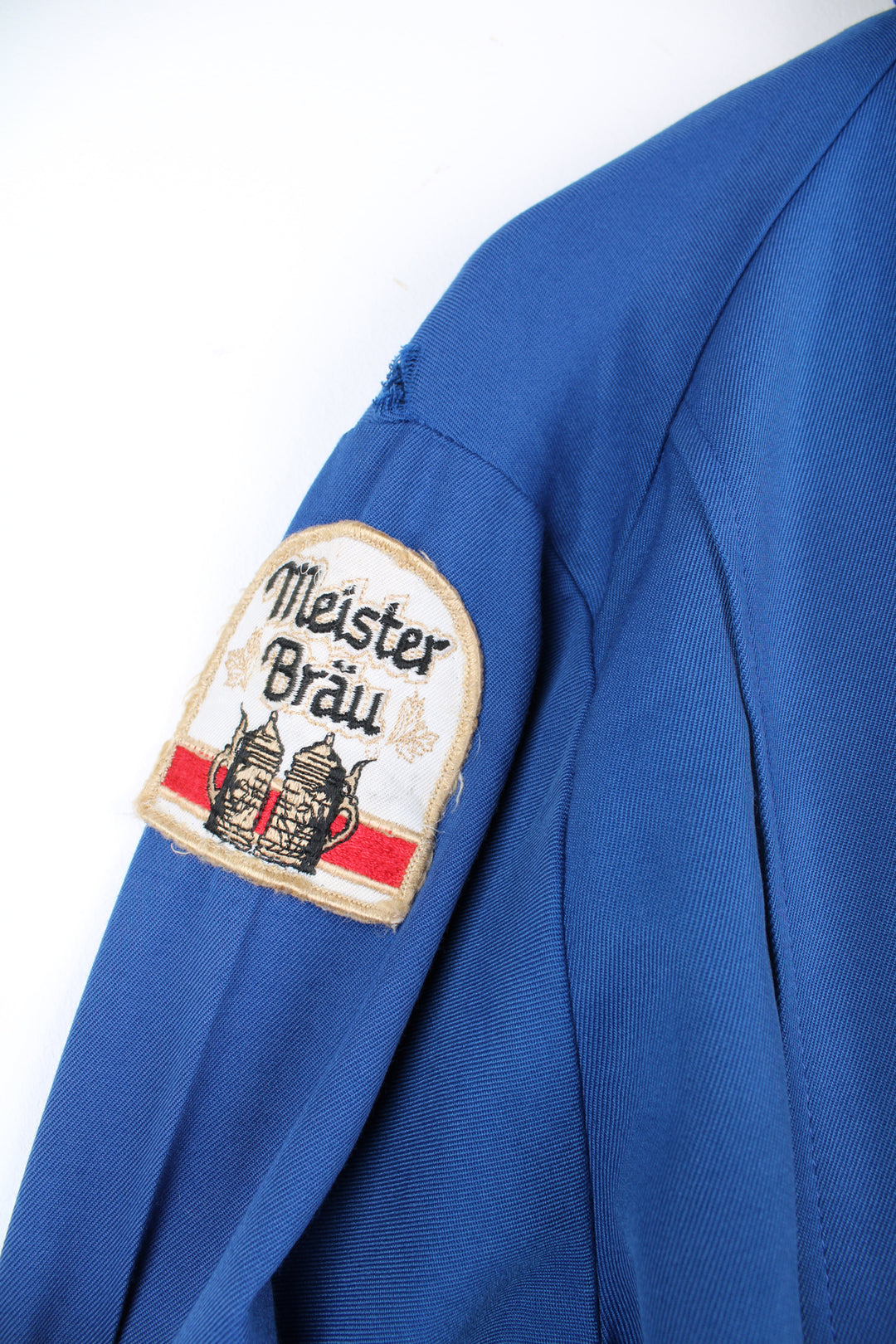 Vintage 1960's delivery drivers jacket from Miller High Life. Features embroidered patches for Miller High Life beer and has chain stitched "Ralph"  on the chest,. Lightweight jacket made from a blue Rayon material, has two front pockets and closes with a full zip. The jacket has a zip inside where it used to have a removable lining (this is missing). 