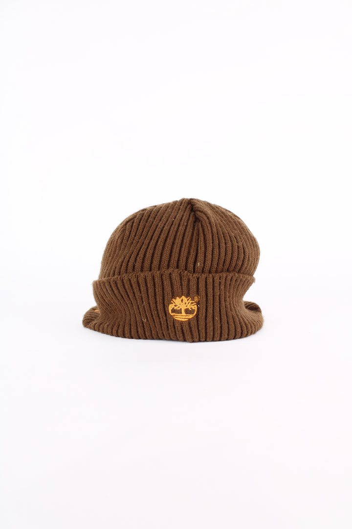 Timberland beanie cap in brown, features orange embroidered logo on the peak and on the back, one size.