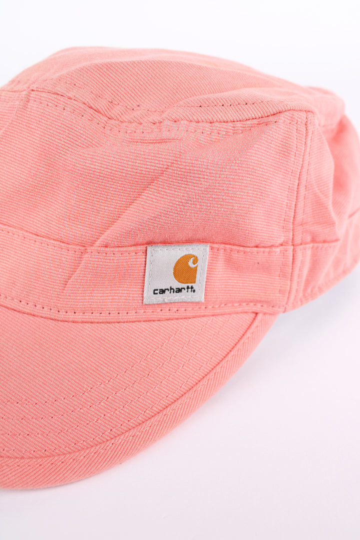 Carhartt pink baker boy style cap with patch logo on the front. Has an adjustable strap at the back. 