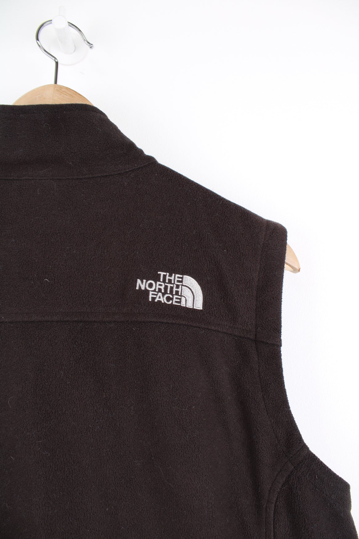 The North Face Fleece Vest in a black colourway, zip up, side pockets, and has the logo embroidered on the front and back.