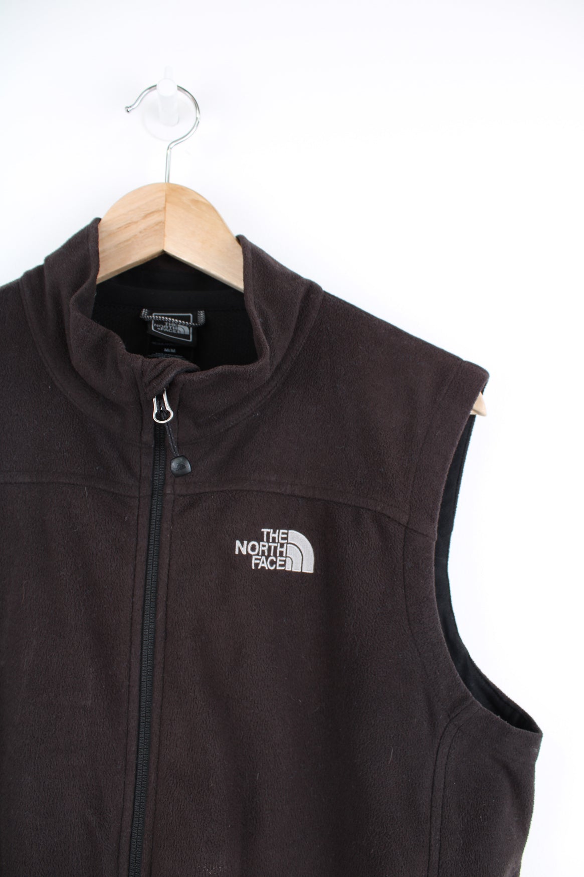 The North Face Fleece Vest in a black colourway, zip up, side pockets, and has the logo embroidered on the front and back.