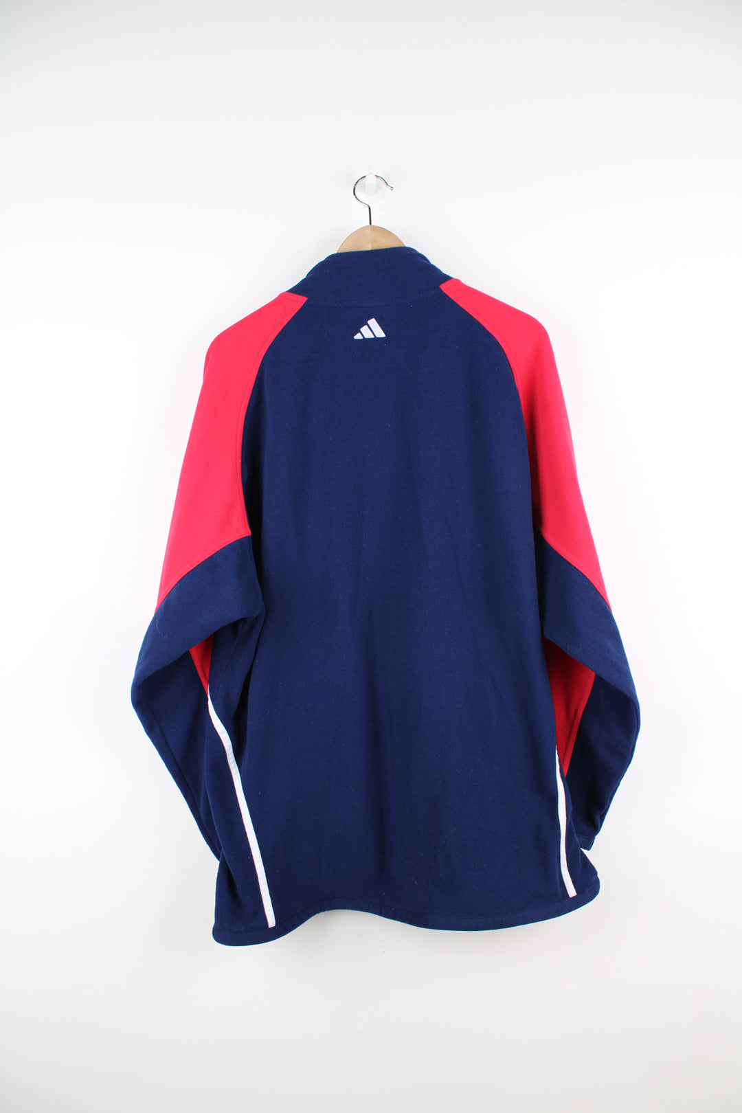 Adidas Fleece in a blue, white and red colourway, quarter zip up, side pockets, adjustable waist and has the logo embroidered on the front and back.