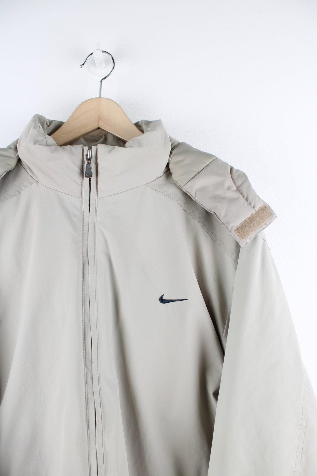 Vintage Nike outdoors jacket in a tan colourway, zip up, side pockets, detachable hood, insulated with a quilted lining, and has swoosh logo embroidered on the front and back.