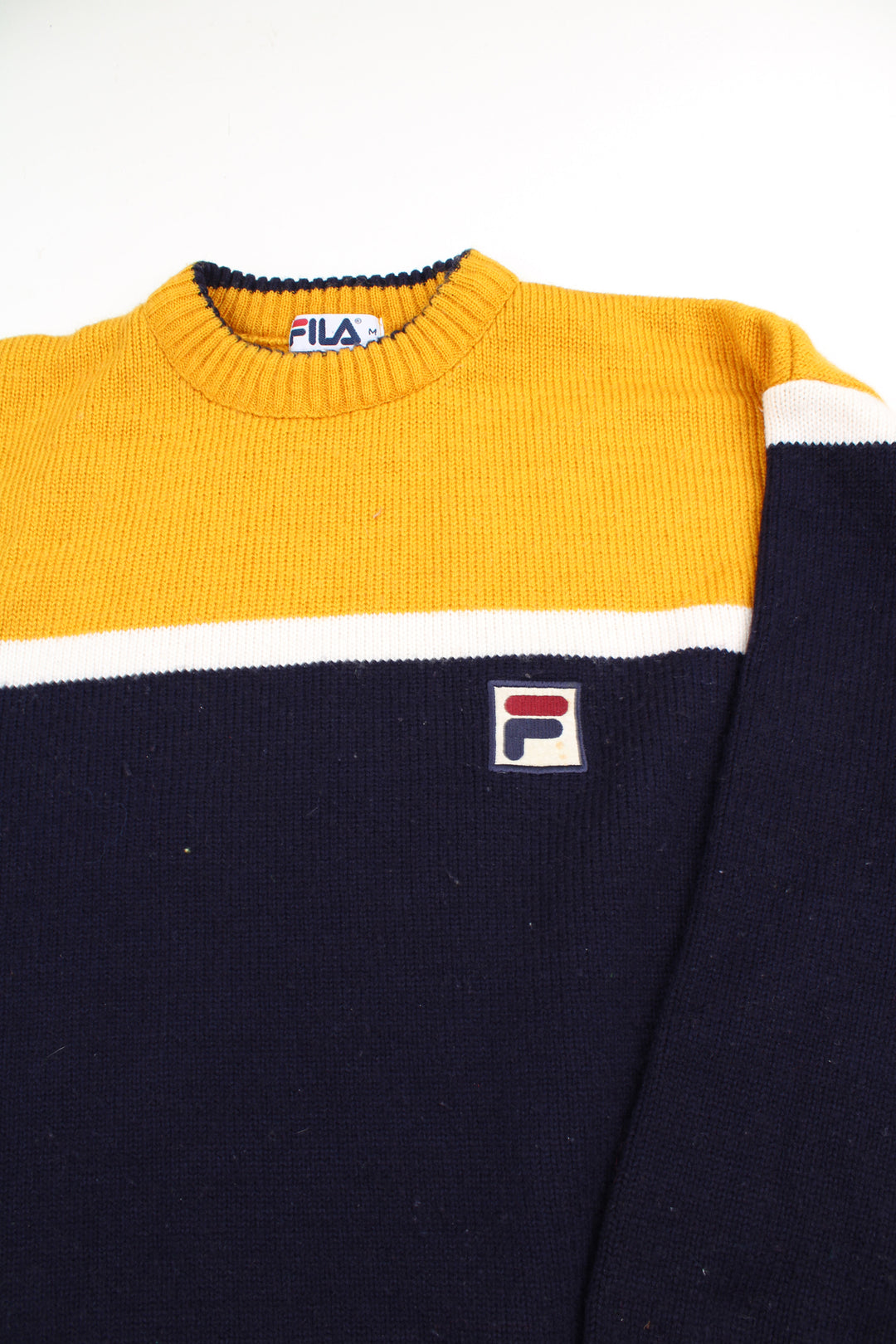 Vintage navy blue and yellow Fila knit jumper with high neck and embroidered logo on the chest 