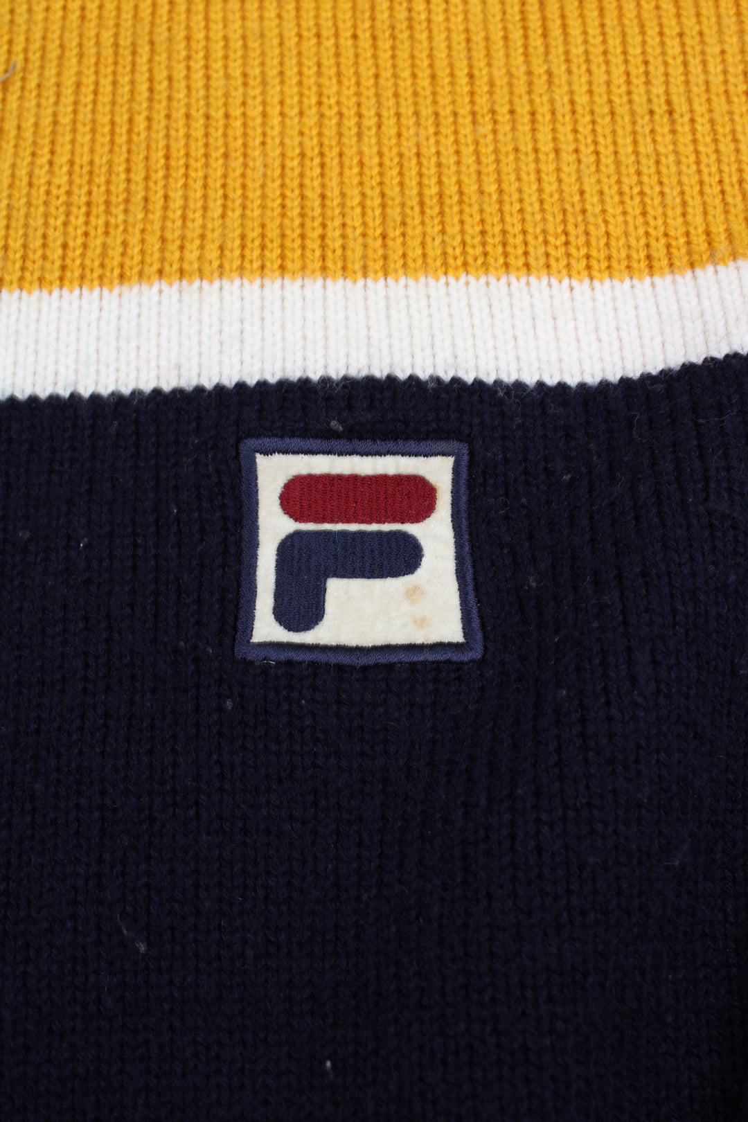 Vintage navy blue and yellow Fila knit jumper with high neck and embroidered logo on the chest 