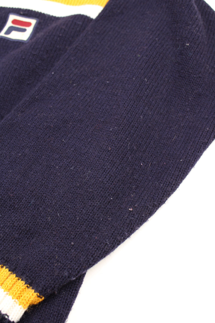 Vintage navy blue and yellow Fila knit jumper with high neck and embroidered logo on the chest 