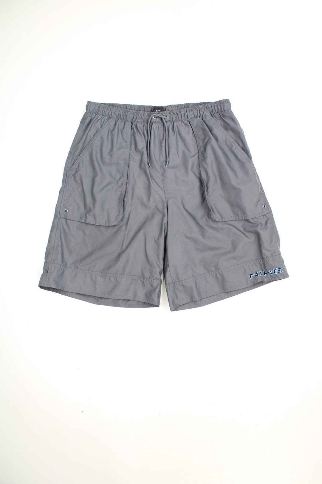 Grey Nike basketball style shorts with embroidered spellout logo on the leg and elasticated waistband. good condition Size in Label:Our Measurements: Mens L 