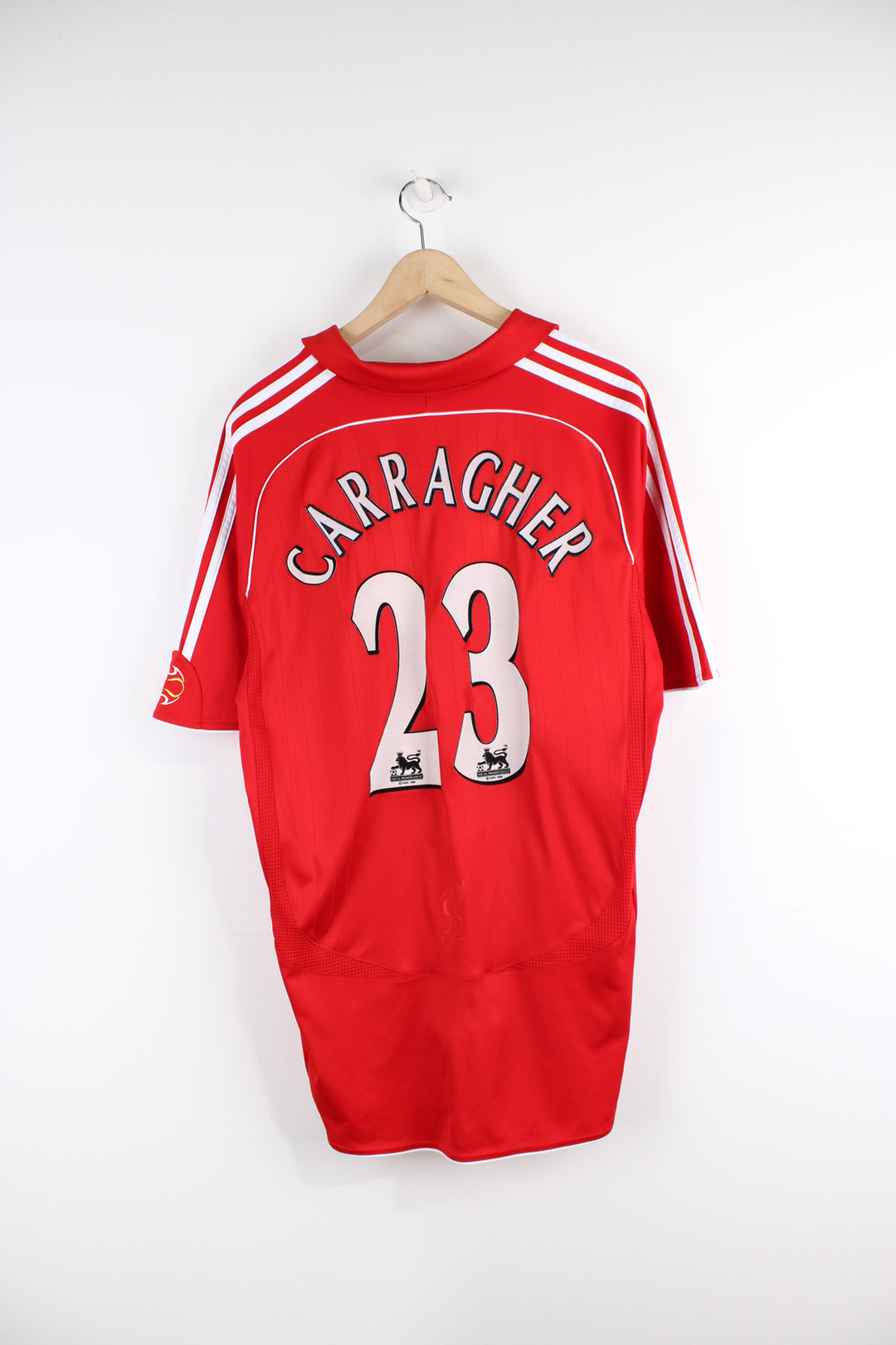 Vintage Liverpool 2006/08, Adidas Home Football Shirt, red and white team colourway, collar, Carragher number 23 printed on the back, and has logos embroidered on the front.