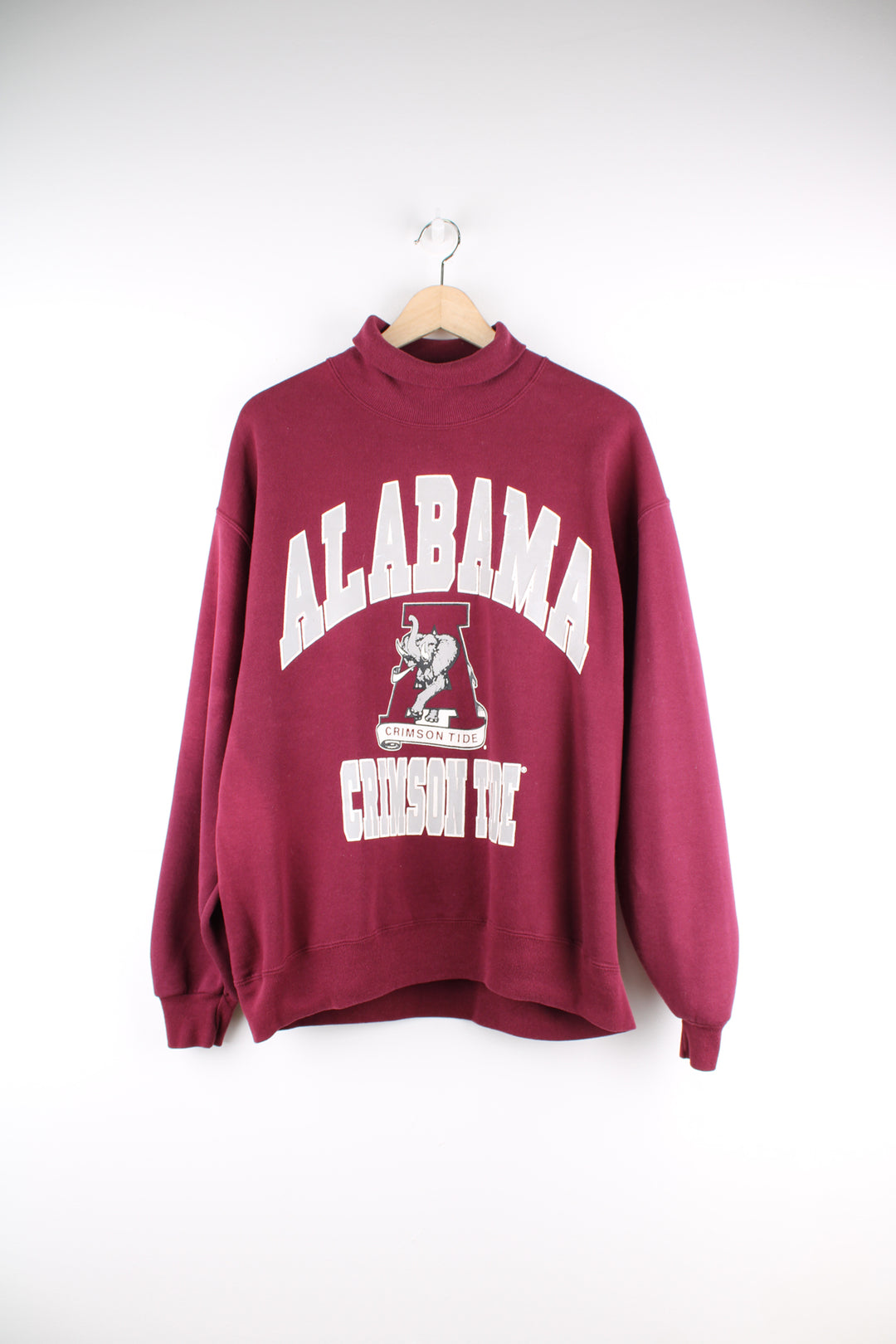 Alabama University Sports Sweatshirt in a maroon colourway, turtle neck, and has spell out logo printed on the front.