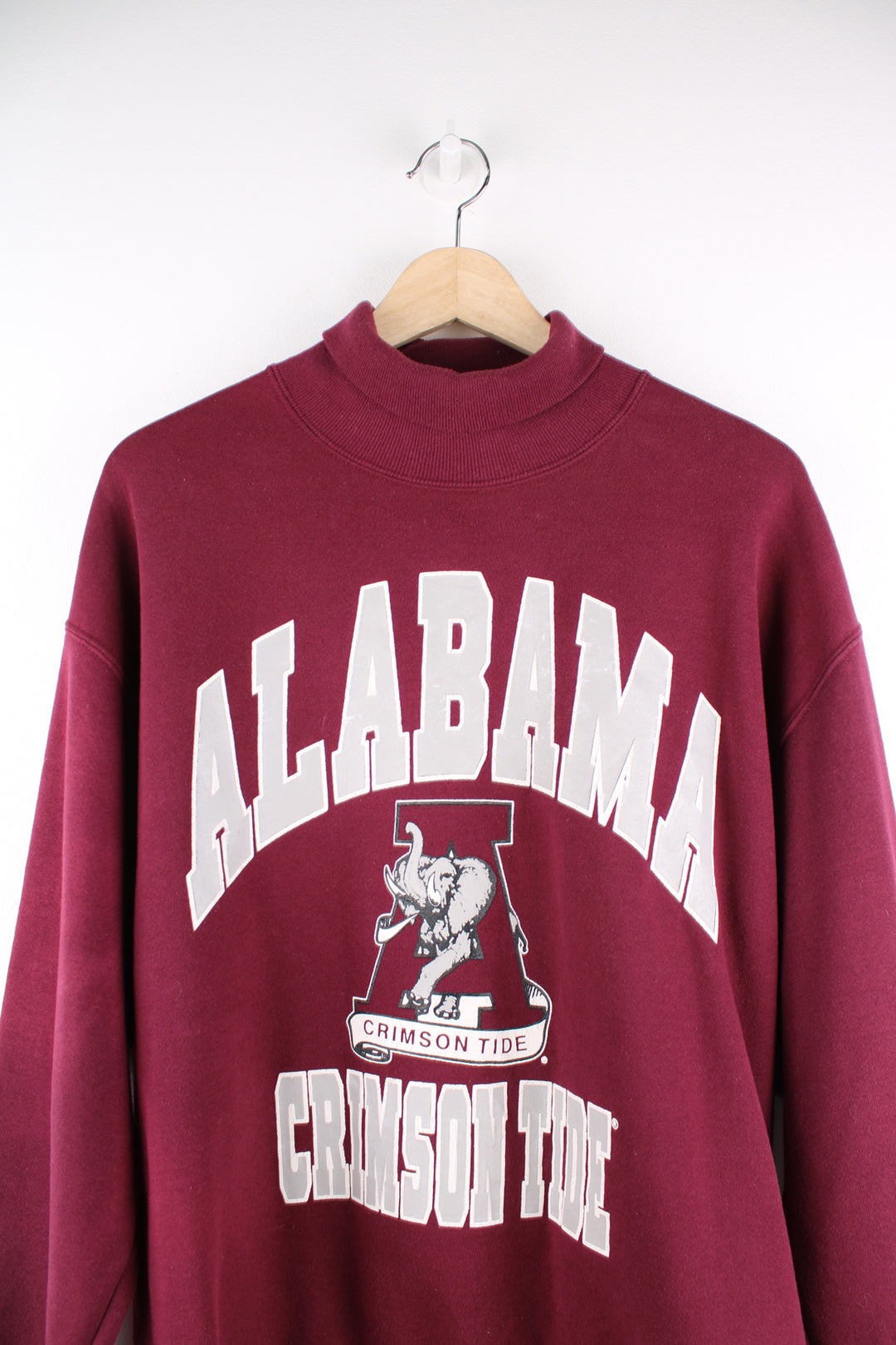 Alabama University Sports Sweatshirt in a maroon colourway, turtle neck, and has spell out logo printed on the front.