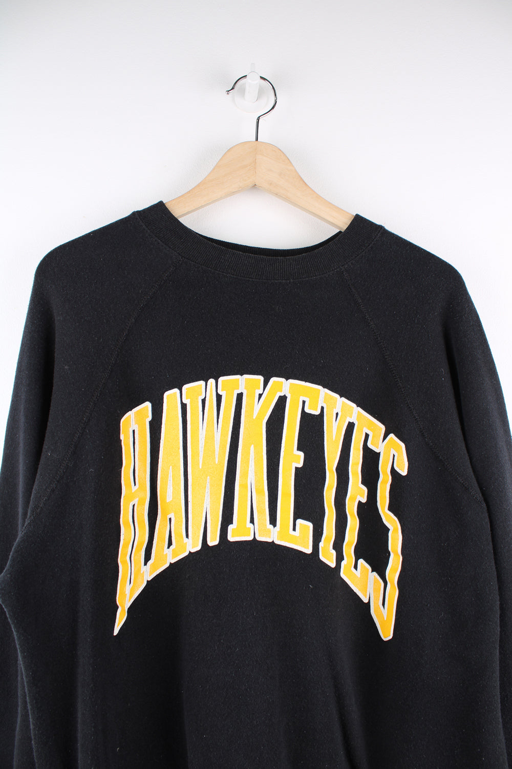 Vintage 90's made in the USA University of Iowa Hawkeyes black crewneck sweatshirt, features printed yellow spell-out details on the front 