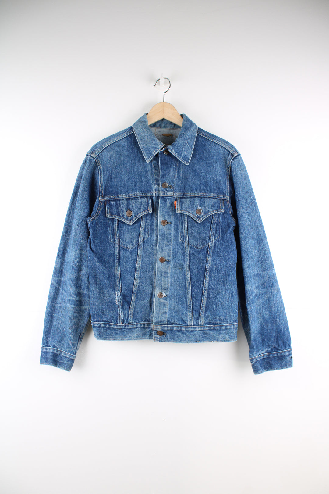 Vintage Levi's denim trucker jacket button up, double chest pockets, and has orange tab logo embroidered on the chest. 