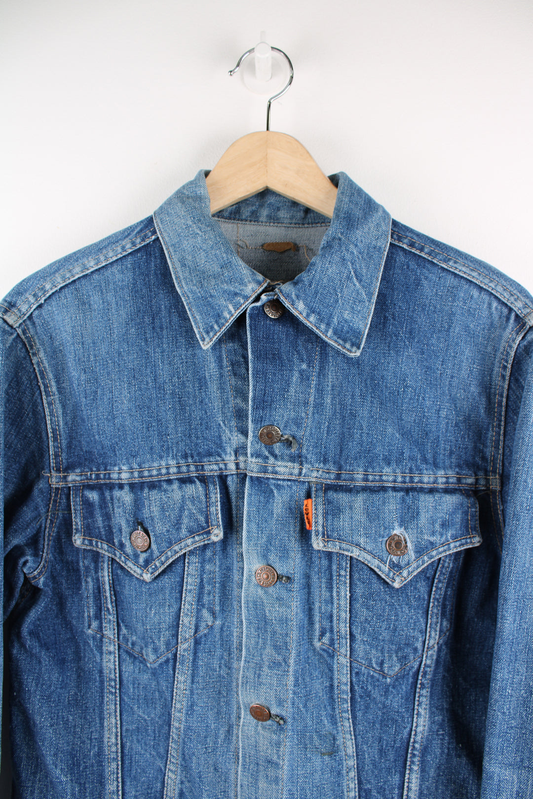 Vintage Levi's denim trucker jacket button up, double chest pockets, and has orange tab logo embroidered on the chest. 