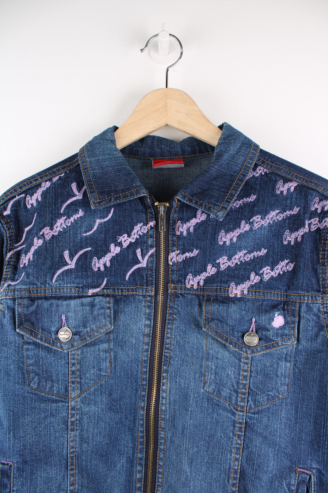 Y2K Apple Bottoms zip through denim jacket, features graffiti like embroidery on the shoulders 