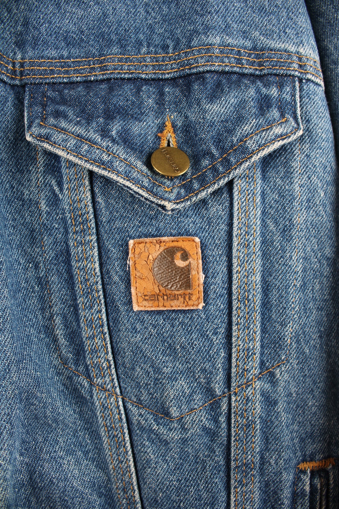 Vintage Carhartt trucker style denim jacket with embroidered Carhartt logo patch