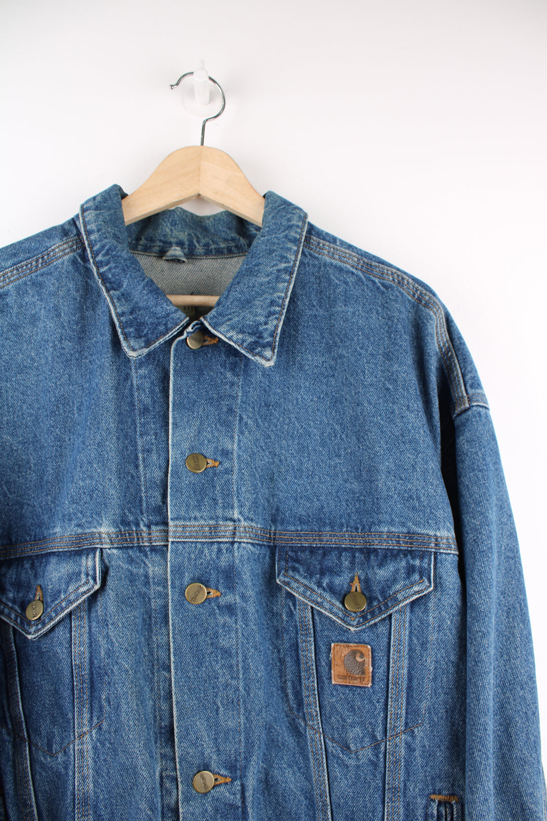 Vintage Carhartt trucker style denim jacket with embroidered Carhartt logo patch