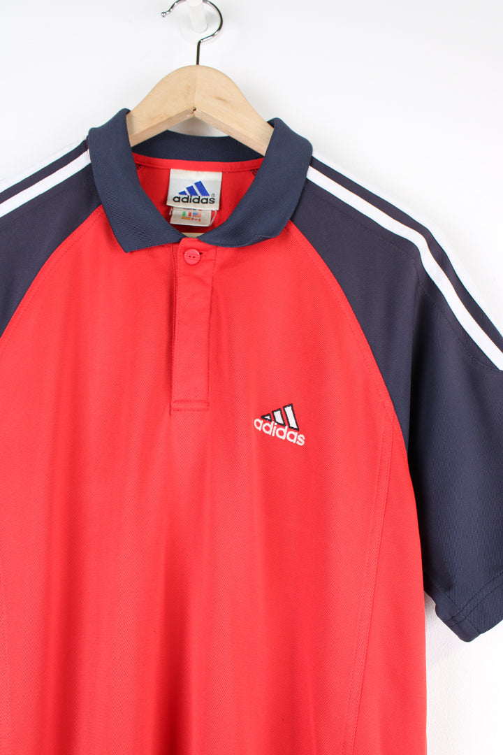 Vintage Adidas Polo Shirt in a red and navy colourway, has the iconic 3 white stripes going down the sleeves, button up with embroidered logo on the chest. 