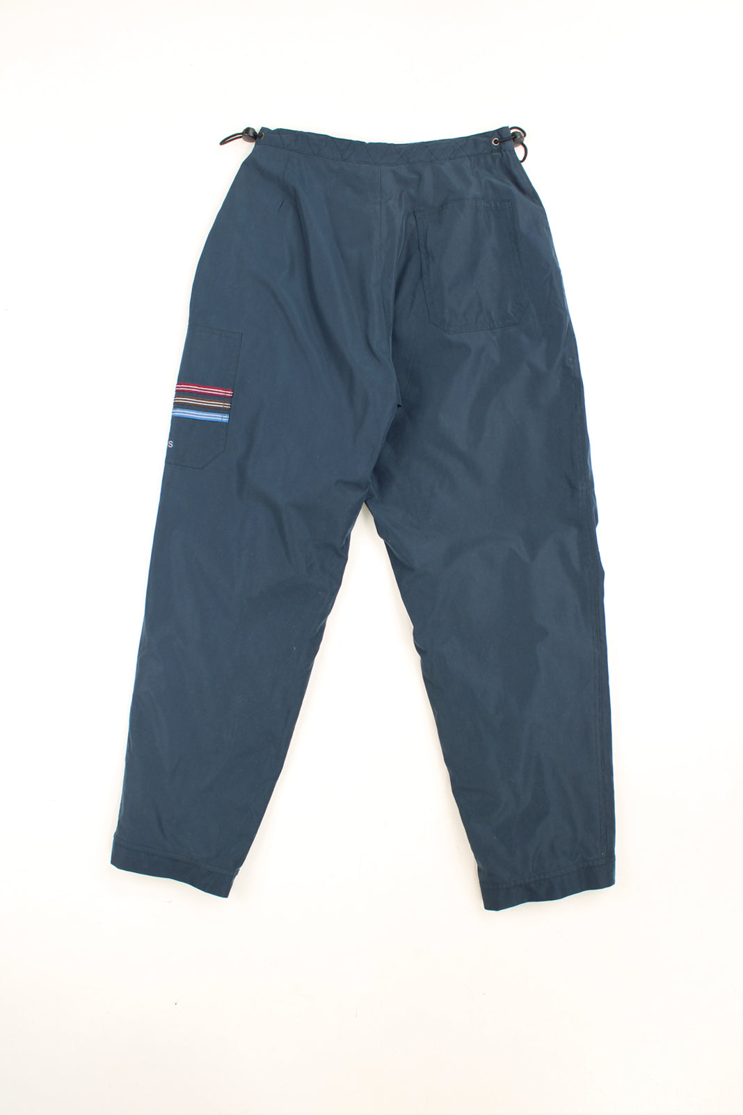 Vintage greyish/ blue Adidas tracksuit bottoms with toggles at the waist and 1/4 zips on the cuffs. Features embroidered logo on the leg. good condition Size in Label:  26" - Measures like a Womens XS