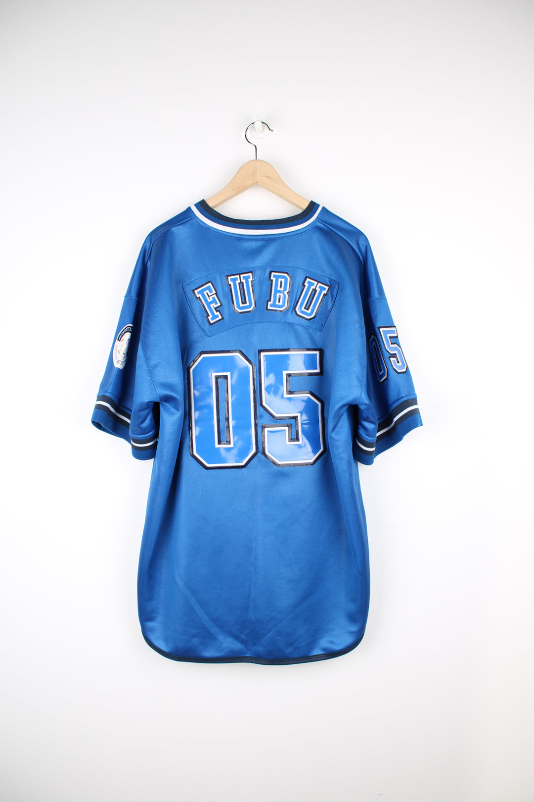 Vintage Y2K Fubu City Series Collection, New York baseball jersey in a blue and black colour way, v neck with embroidered logos and Fubu number 5 on the back. 