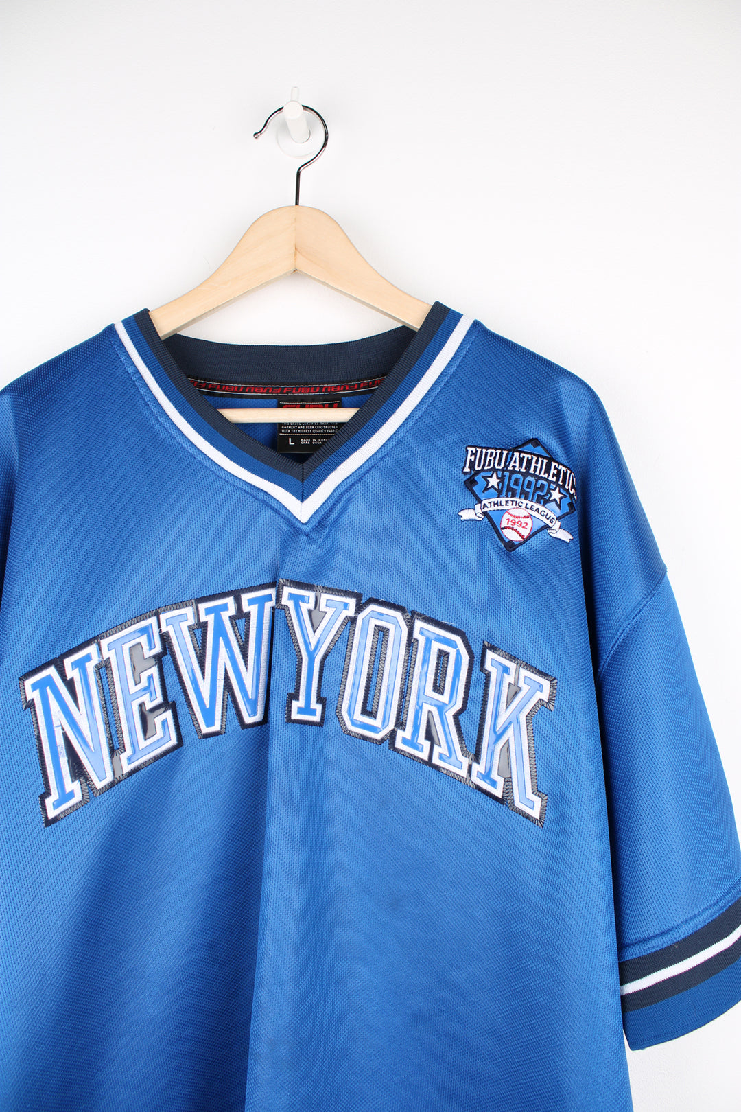 Vintage Y2K Fubu City Series Collection, New York baseball jersey in a blue and black colour way, v neck with embroidered logos and Fubu number 5 on the back. 