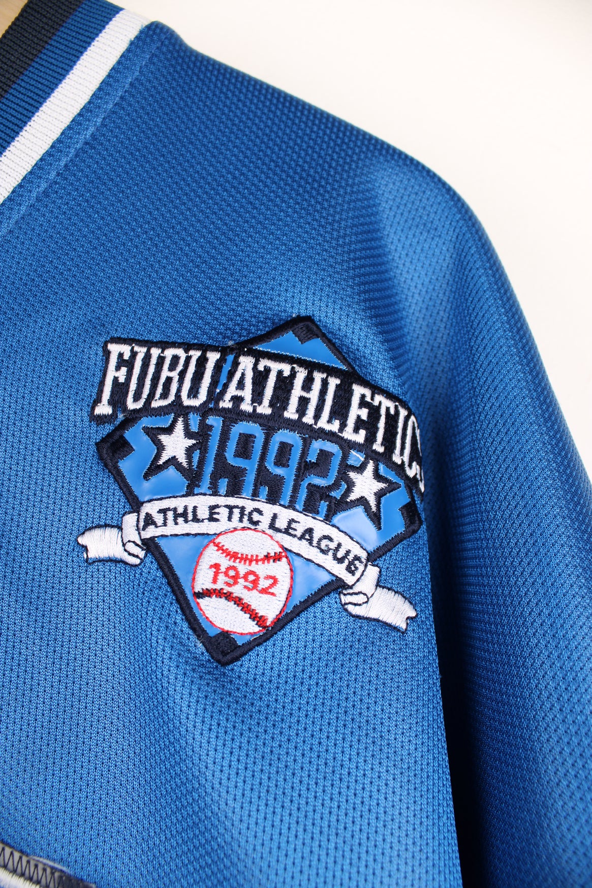 Vintage Y2K Fubu City Series Collection, New York baseball jersey in a blue and black colour way, v neck with embroidered logos and Fubu number 5 on the back. 