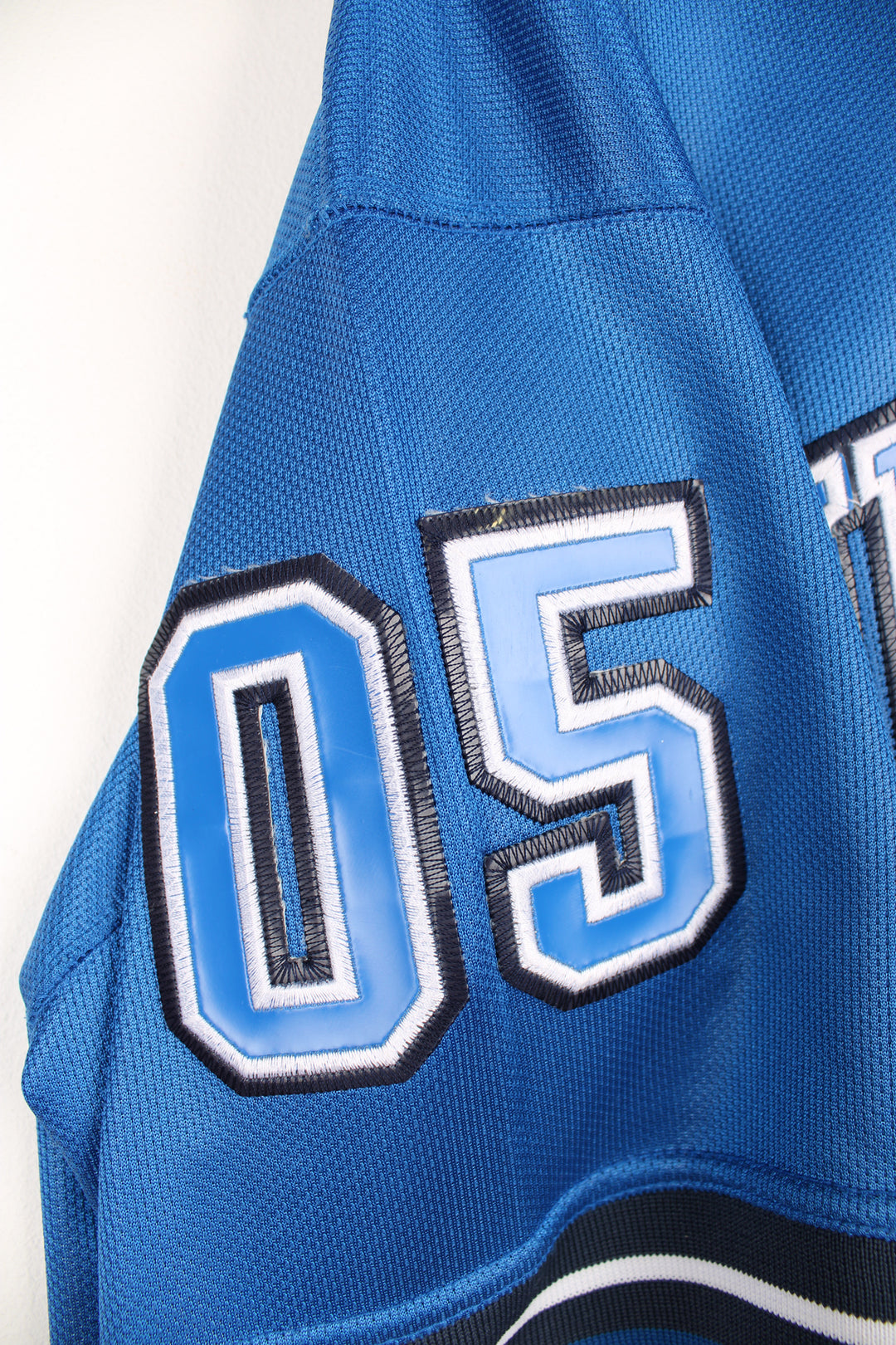 Vintage Y2K Fubu City Series Collection, New York baseball jersey in a blue and black colour way, v neck with embroidered logos and Fubu number 5 on the back. 