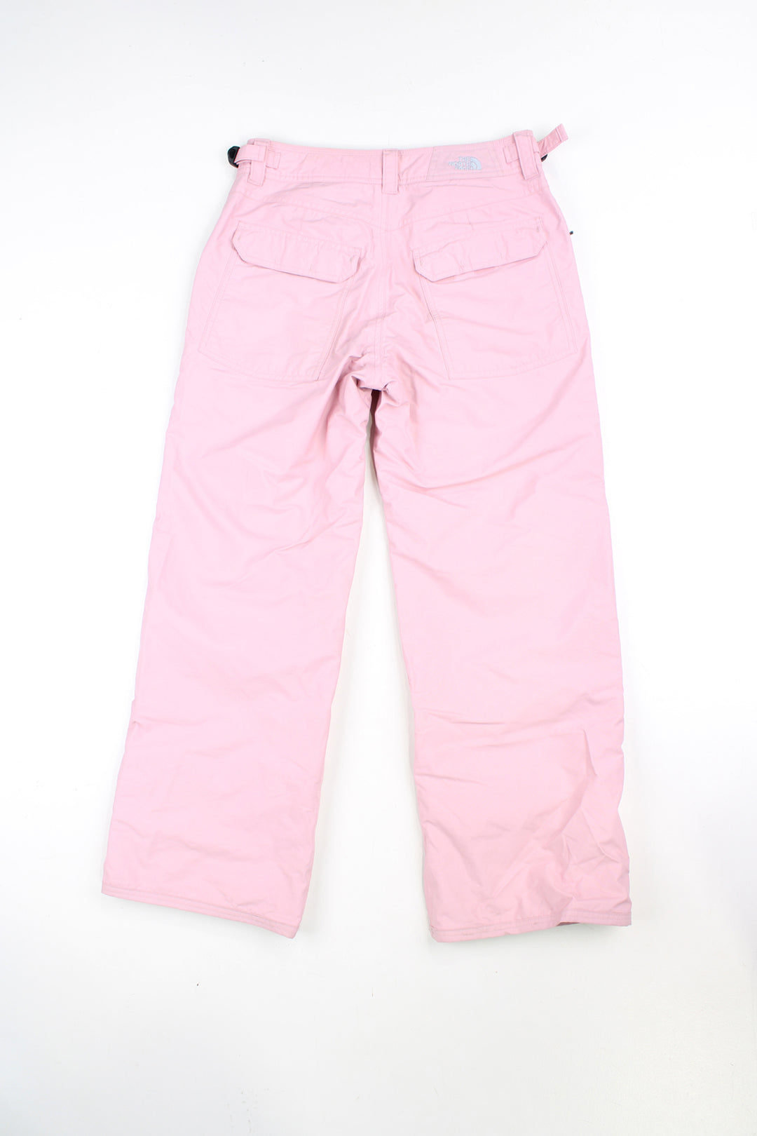 The North Face Hyvent baby pink fleece lined salopettes, features zip up pockets and embroidered logo on the leg