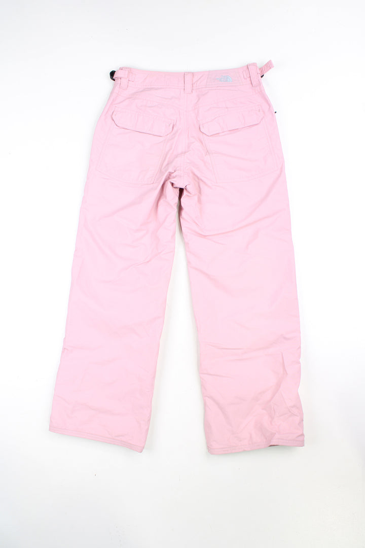 The North Face Hyvent baby pink fleece lined salopettes, features zip up pockets and embroidered logo on the leg