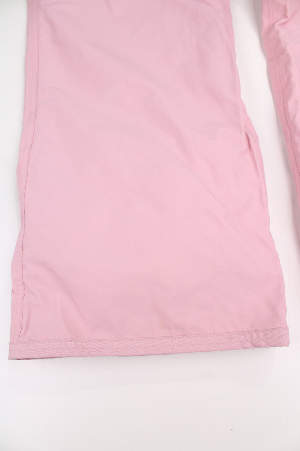 The North Face Hyvent baby pink fleece lined salopettes, features zip up pockets and embroidered logo on the leg