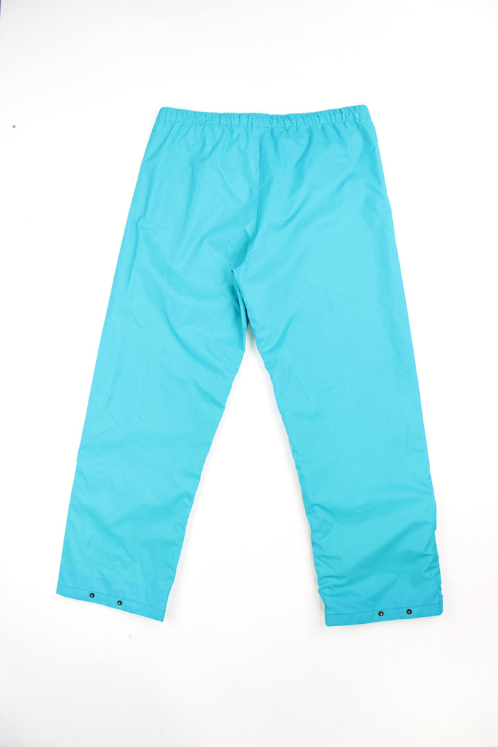 Vintage Helly Tech bright blue tech trousers by Helly Hansen, features drawstring waist and embroidered logo on the hip 