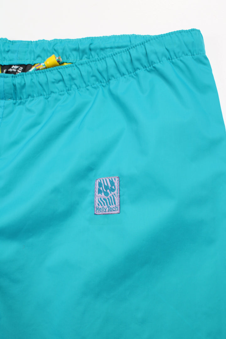 Vintage Helly Tech bright blue tech trousers by Helly Hansen, features drawstring waist and embroidered logo on the hip 