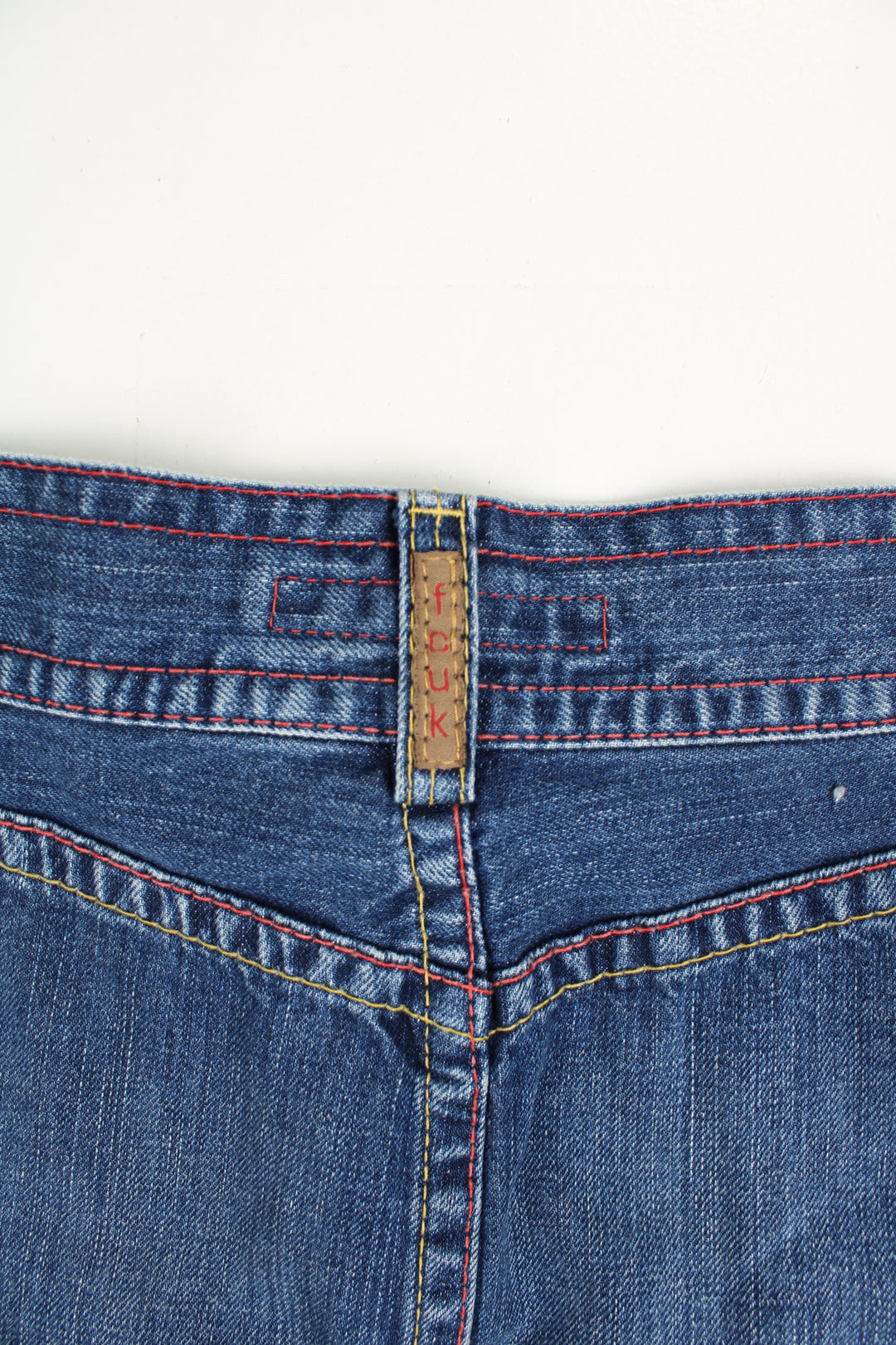 Vintage Y2K low rise FCUK denim mini skirt. Features silver hardwear and red and yellow contrast stitching. good condition  Size in label:   Womens 12