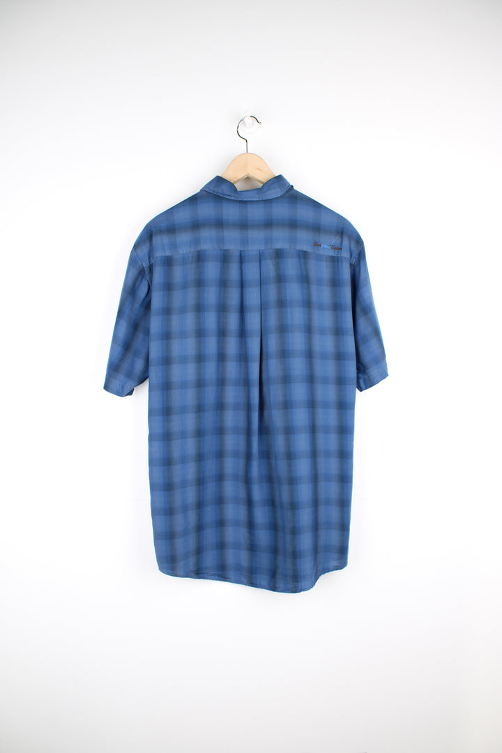 Quiksilver dark blue plaid button up shirt features chest pocket and embroidered logo on the back of the shoulder