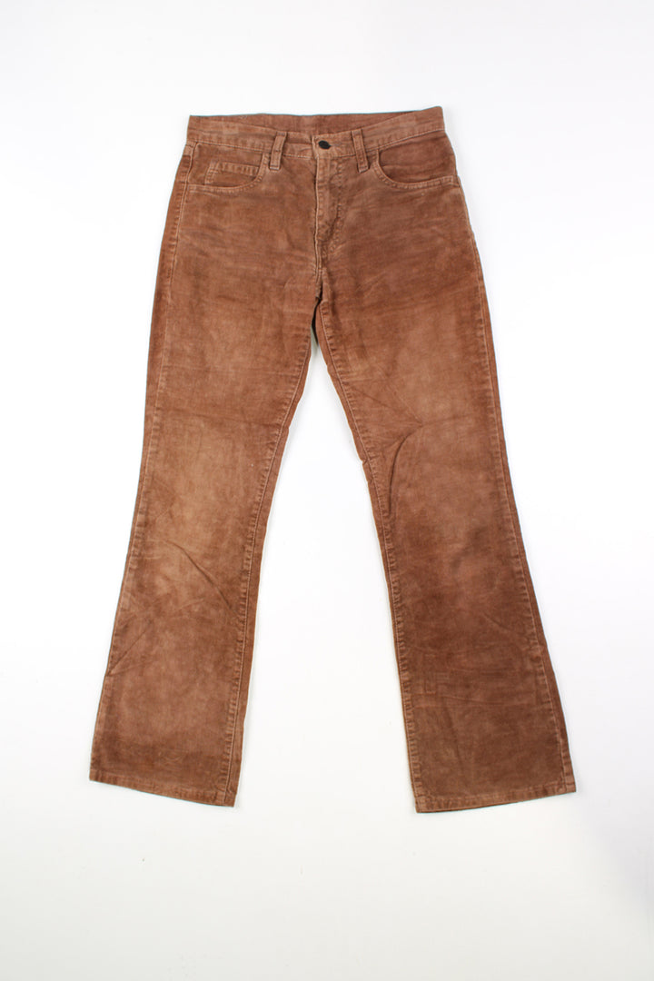 Vintage brown Levi Strauss 525 velvet trousers with white tab on back pocket. Slightly boot cut legs.