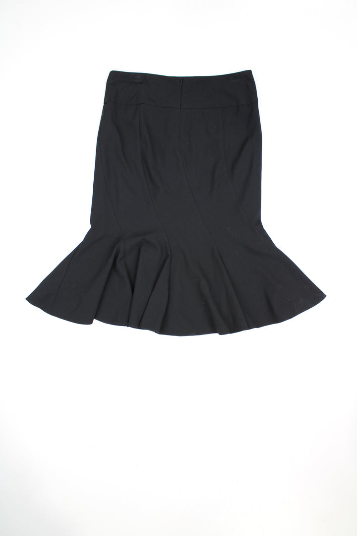 Vintage Y2K black knee length skirt. detail at the front. Could be worn mid or low rise depending on measurements. Features paneling that is cut on the bias to create ruffles at the hem.   good condition  Size in label:   40 - Measures as a Womens size 10 (S) when worn low rise.