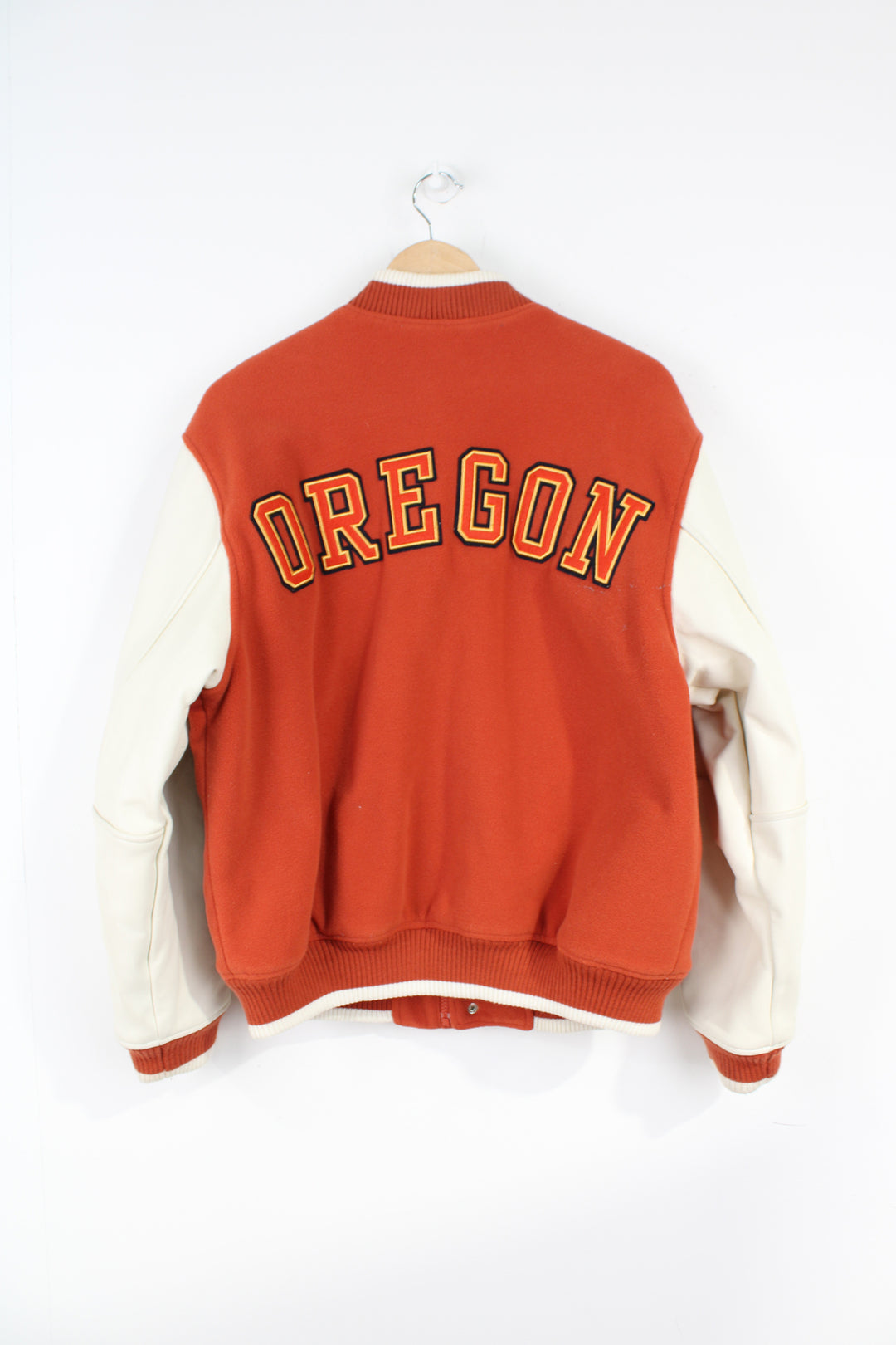 Vintage Nike Oregon orange and white fleece varsity jacket with leather sleeves and embroidered spell-out details