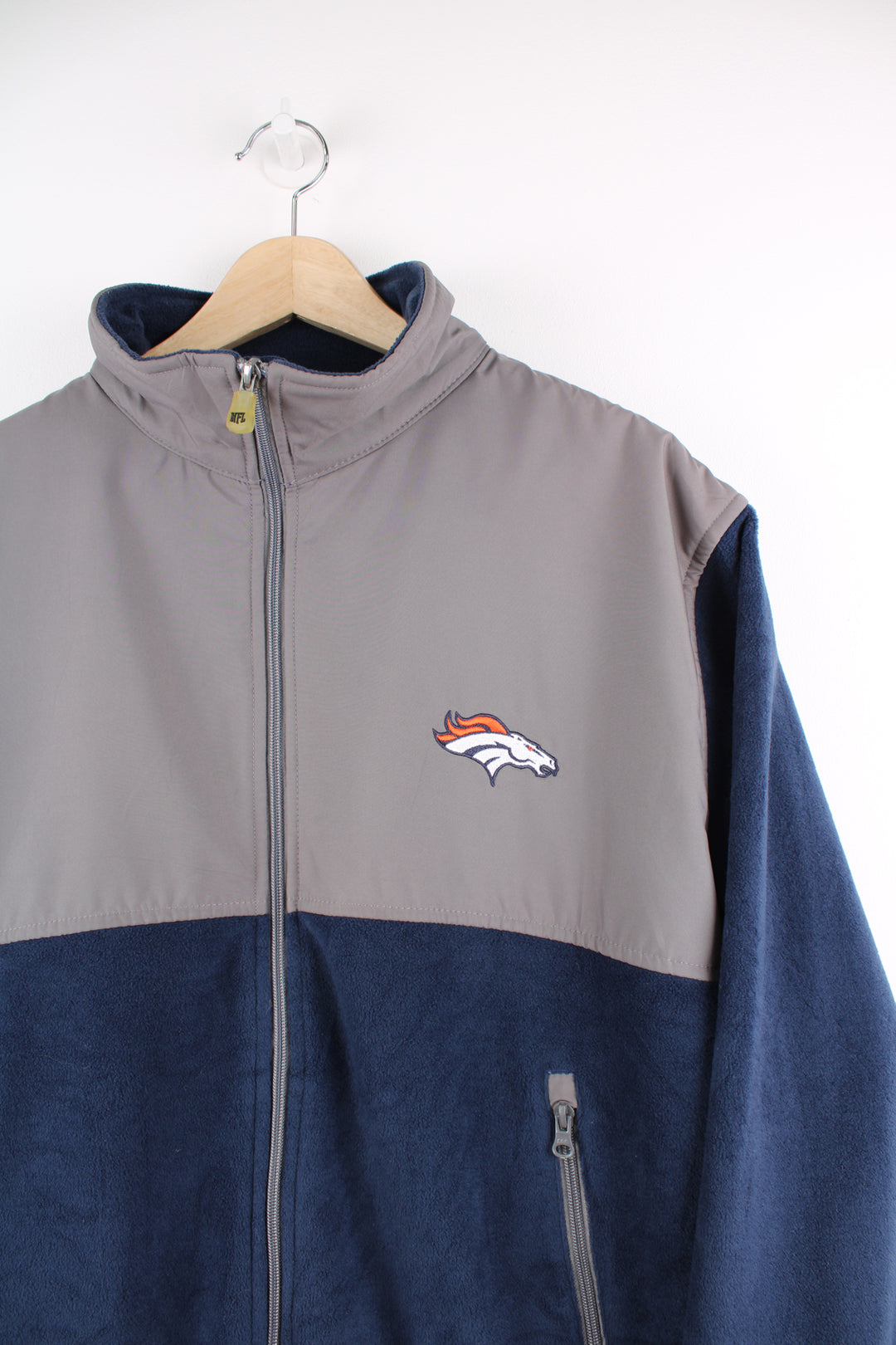 Denver Broncos navy blue and grey zip through fleece features embroidered logo on the chest and zip up pockets 