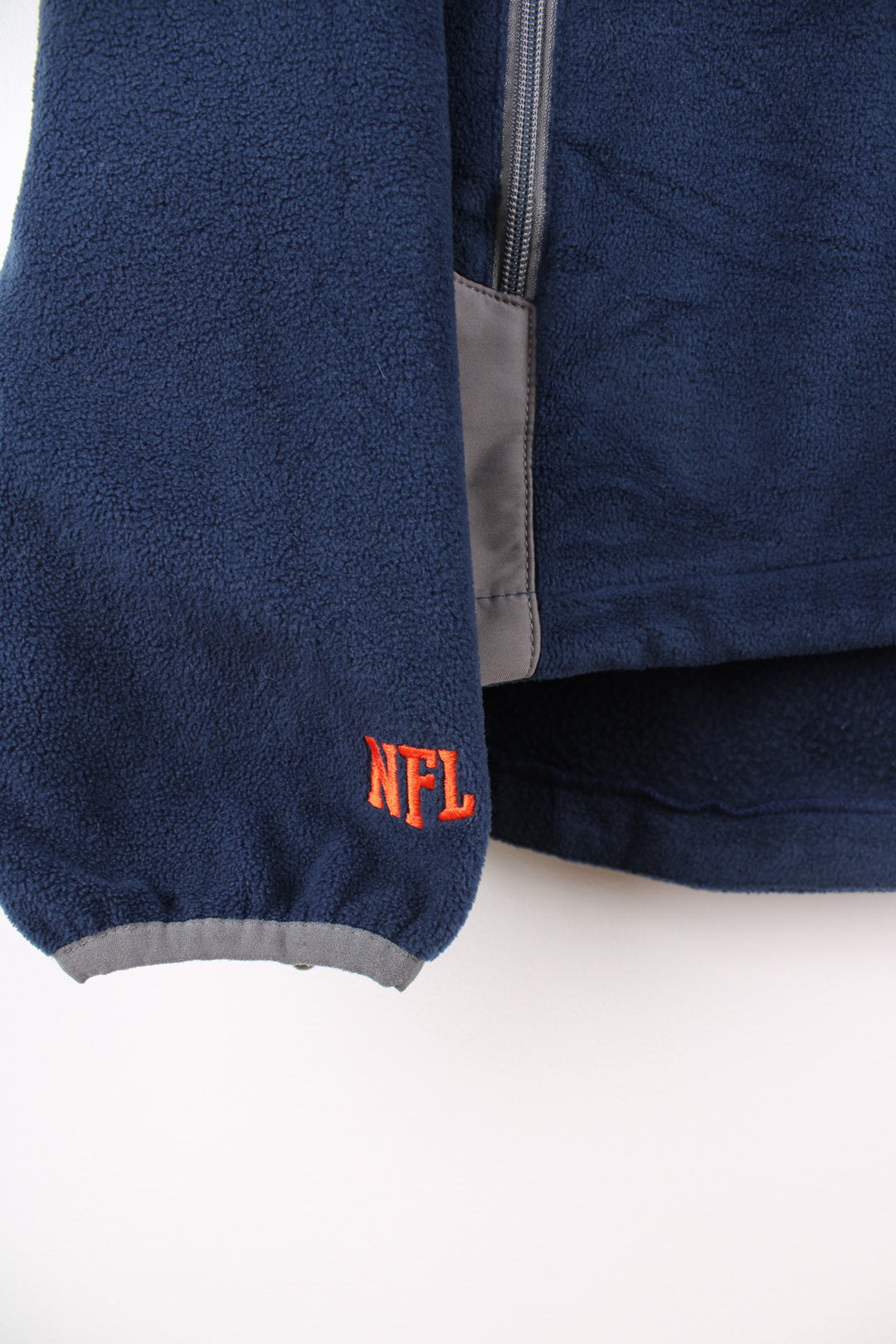 Denver Broncos navy blue and grey zip through fleece features embroidered logo on the chest and zip up pockets 