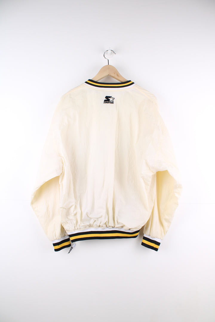 Vintage Pittsburg Steelers cream/off white nylon pullover training top by Starter with embroidered spell-out details across the chest and logo on the cuff