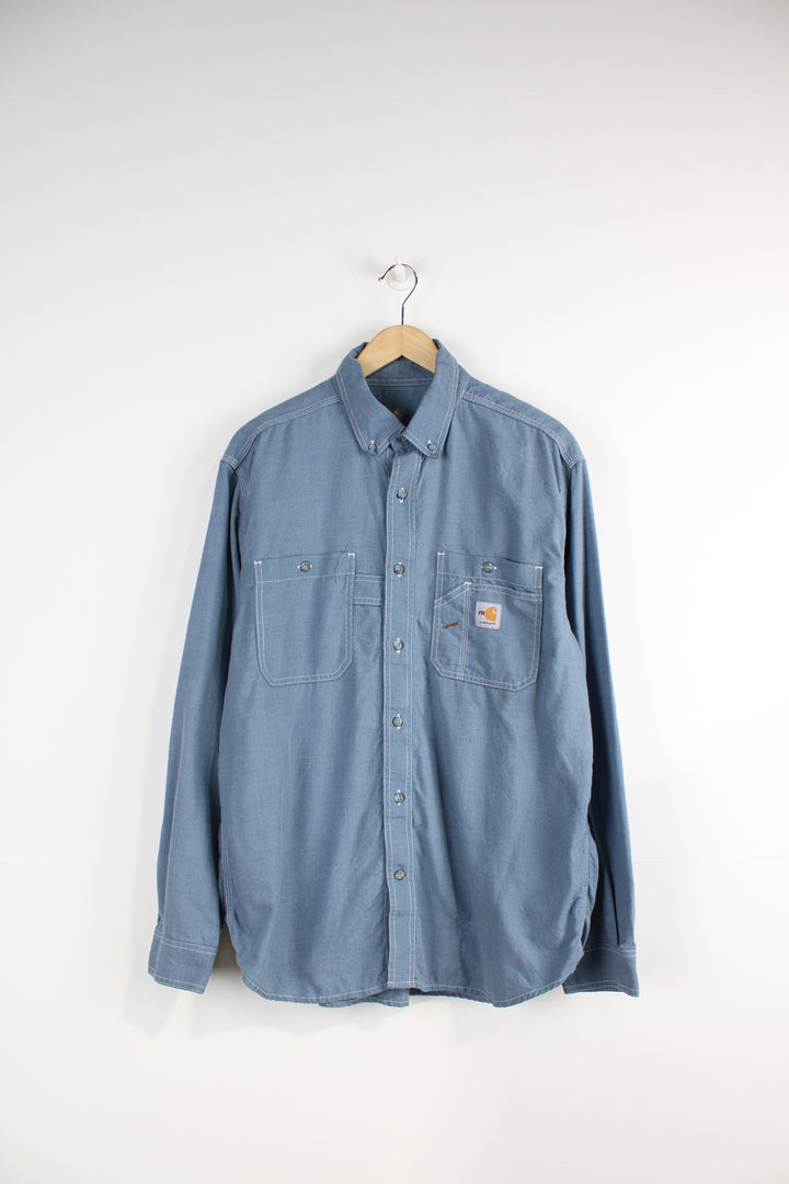 Carhartt Denim Shirt, light blue colourway, button up, chest pockets and has logo embroidered on the front. 