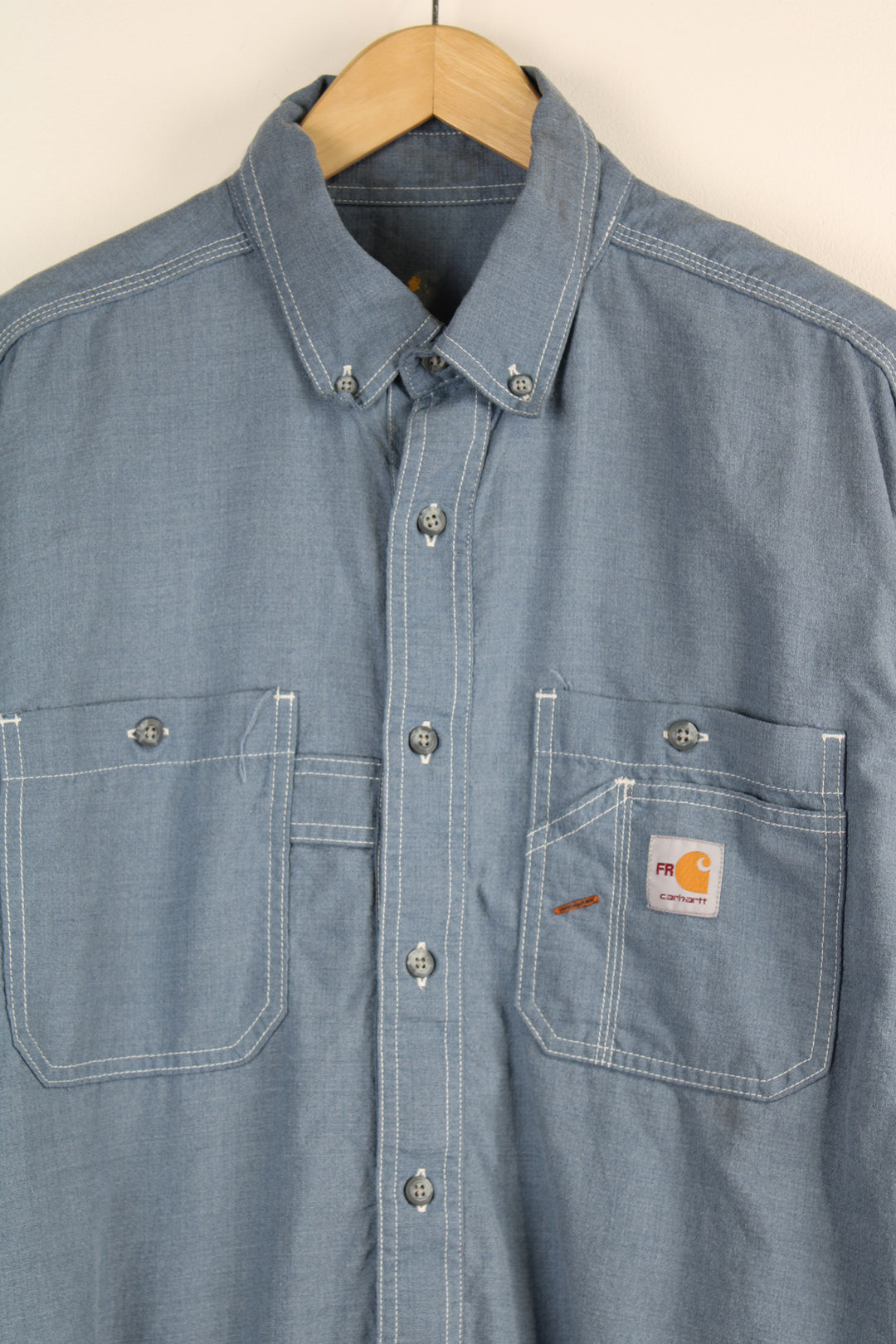 Carhartt Denim Shirt, light blue colourway, button up, chest pockets and has logo embroidered on the front. 