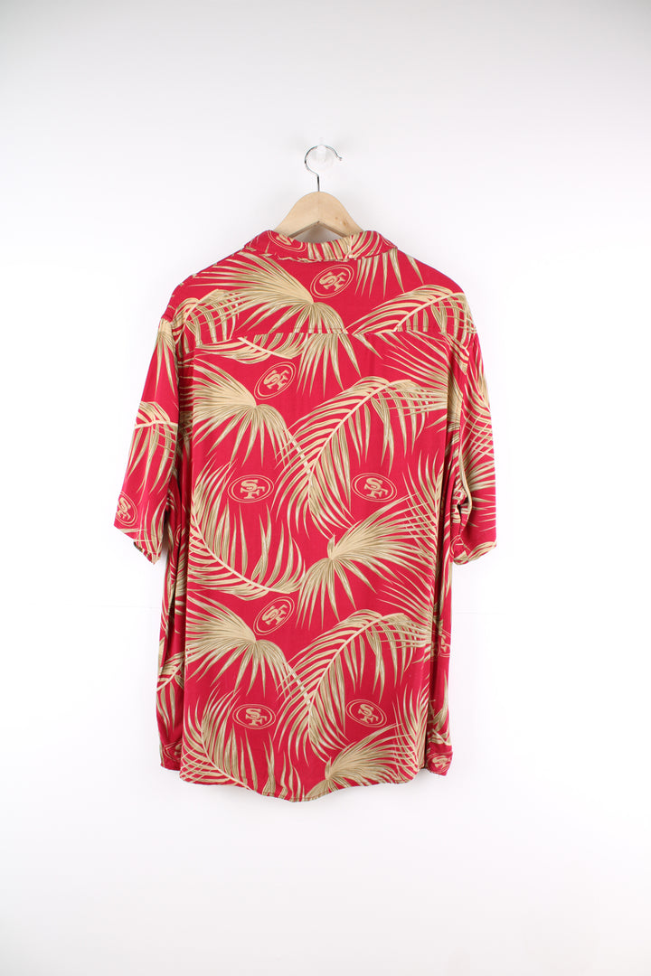 San Francisco 49ers Hawaiian Shirt in a red and gold colourway, floral design with the team logo printed all over, button up and has a chest pocket.