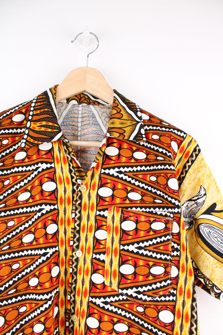 Vintage 70's Hawaiian Shirt in a orange, white and yellow colourway, patterned design printed all over, button up with a camp collar and has a chest pocket.