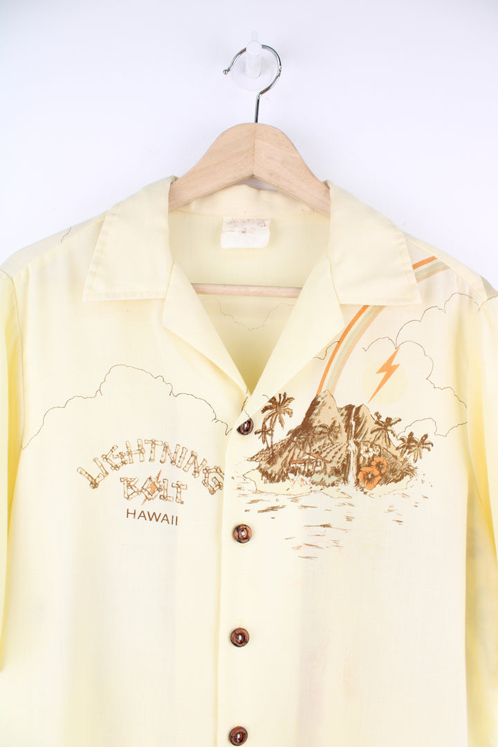 Vintage Lightning Bolt Hawaiian Shirt in a tan colourway, Hawaii Island design printed on the front and back, button up and has a camp collar.