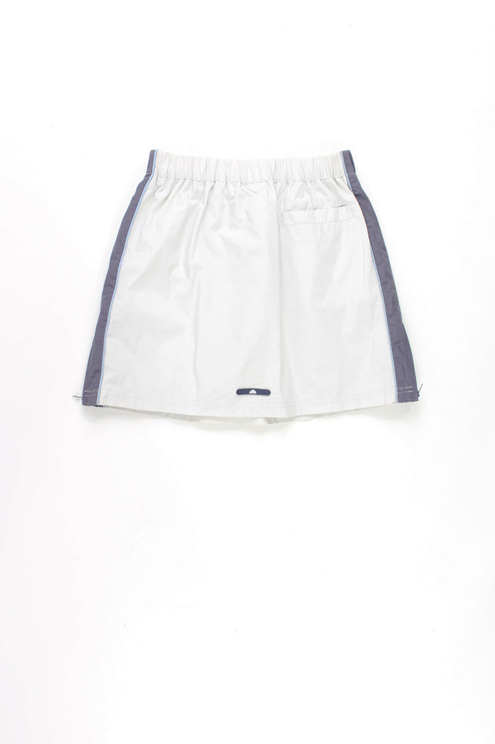 Ellesse light grey and blue sporty style mini skirt, with elasticated drawstring waist, 3D logo on the hem and adjustable zips on the sides 