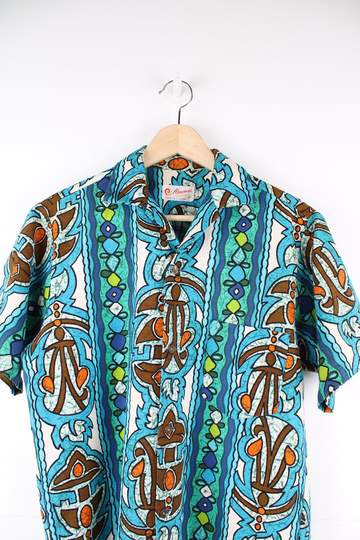 Vintage 60's Hawaiian Shirt in a blue colourway, tribal style print all over, button up with a camp collar and has a chest pocket.