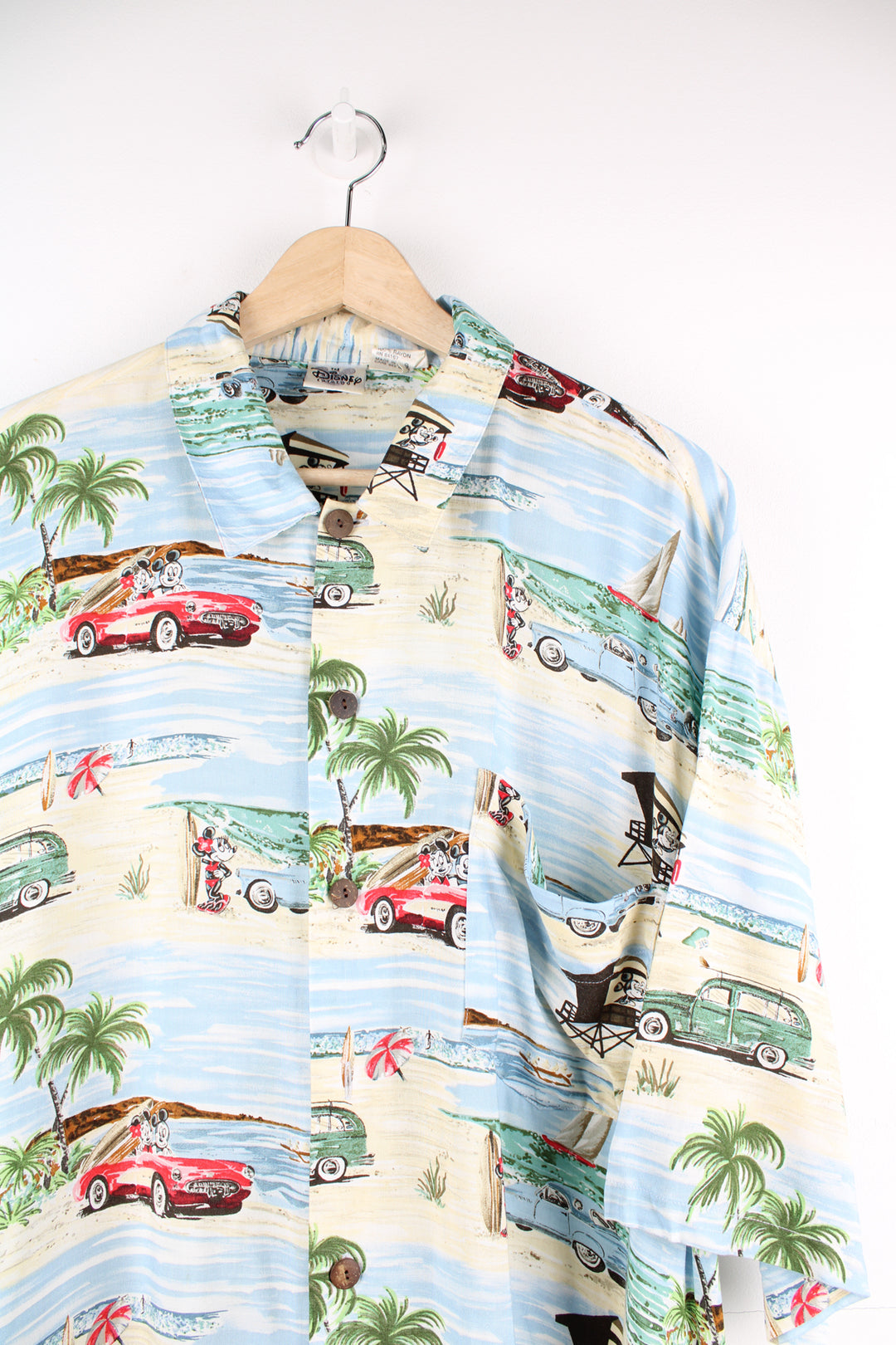 Disney Mickey Mouse Hawaiian Shirt in a blue and tanned colourway, car and island style print all over, button up and has a chest pocket.