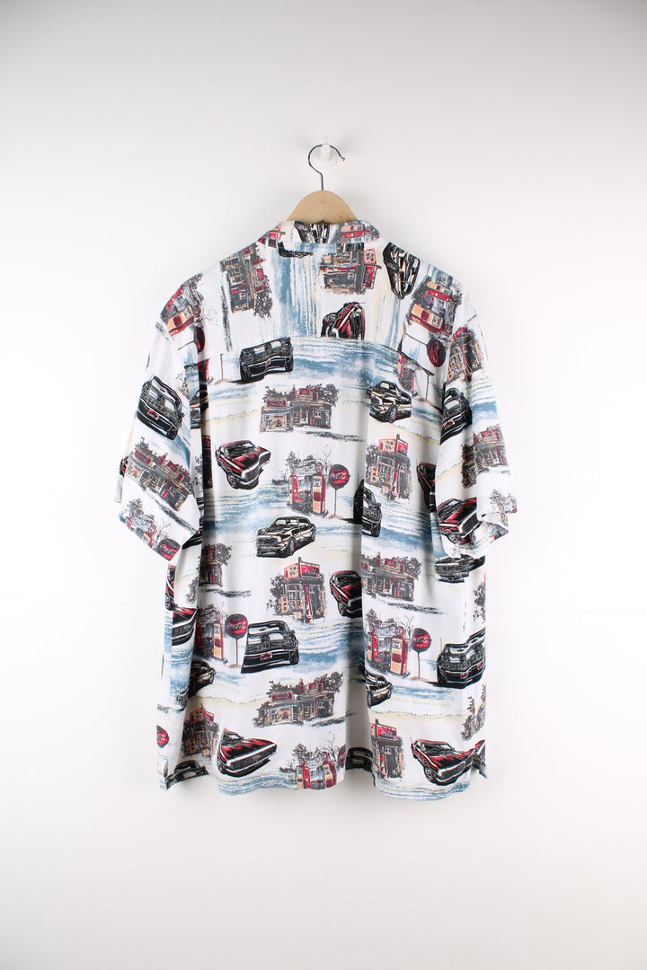 Coca Cola Hawaiian Shirt in a white colourway with cars and petrol station design printed all over, button up and has a chest pocket.