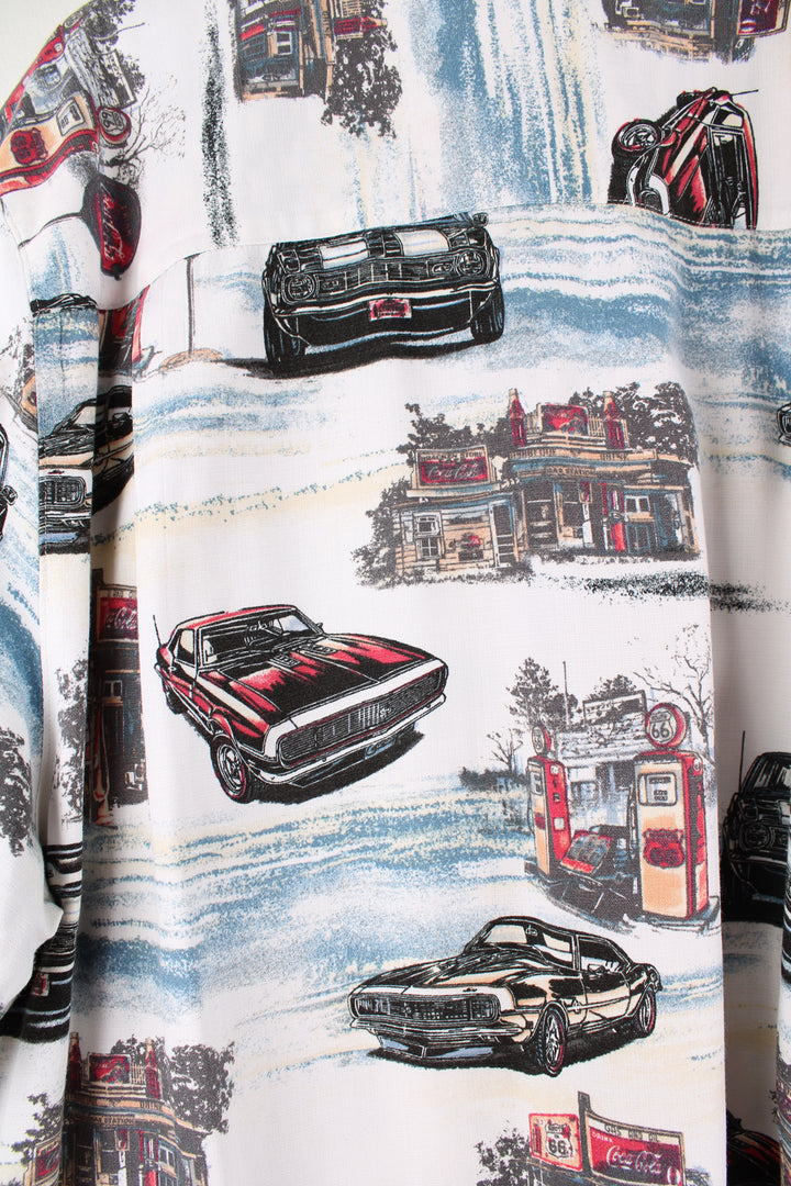 Coca Cola Hawaiian Shirt in a white colourway with cars and petrol station design printed all over, button up and has a chest pocket.