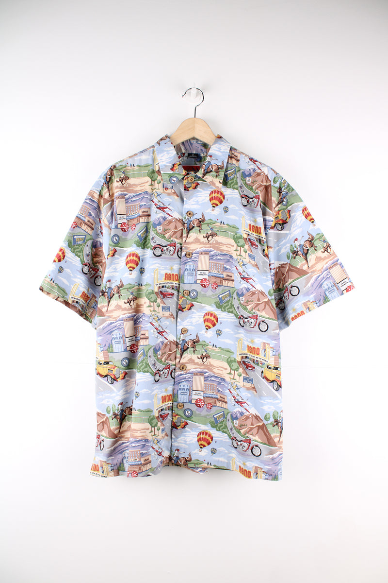 Vintage Dem Crazy Hawaiian Shirt in a blue colourway with gambling and rodeo style design printed all over, button up and has a chest pocket.